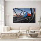 Tableau Décoratif camion remorque en verre acrylique, accroché dans un salon lumineux au-dessus d'un canapé beige