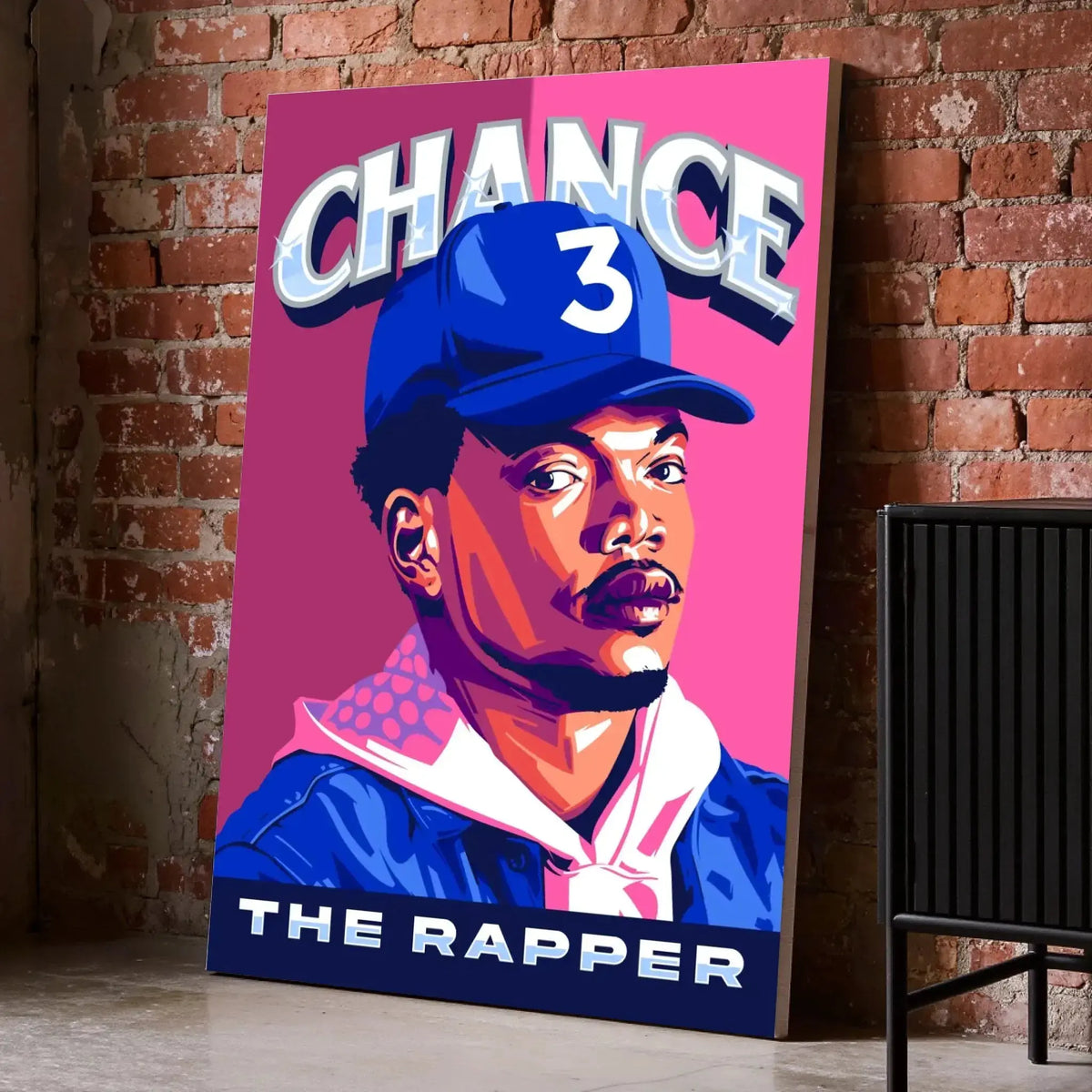 Tableau Décoratif Chance The Rapper sur toile, posé au sol contre un mur de briques rouges