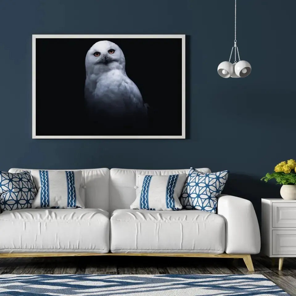 Tableau Décoratif Chouette Blanche en affiche encadrée dans un salon bleu nuit au-dessus d'un canapé blanc