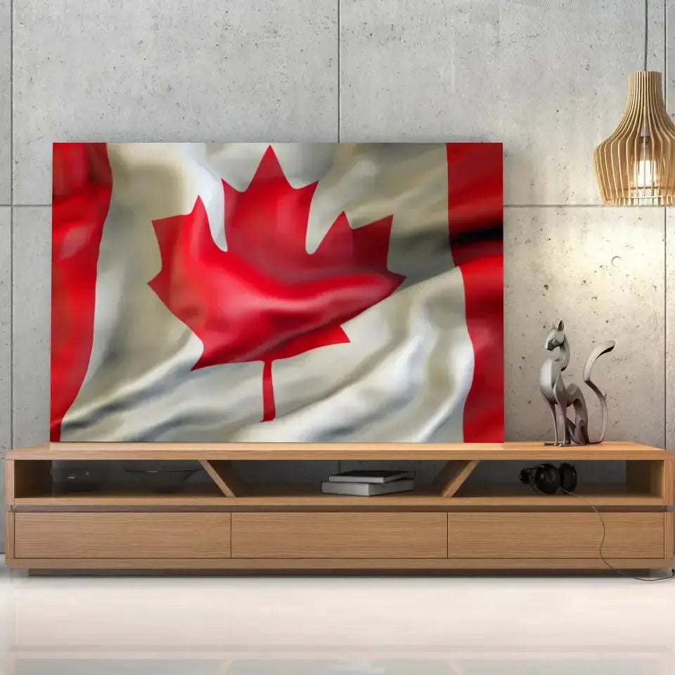 Tableau Drapeau Canada sur toile, posée sur un meuble TV en bois devant un mur en béton
