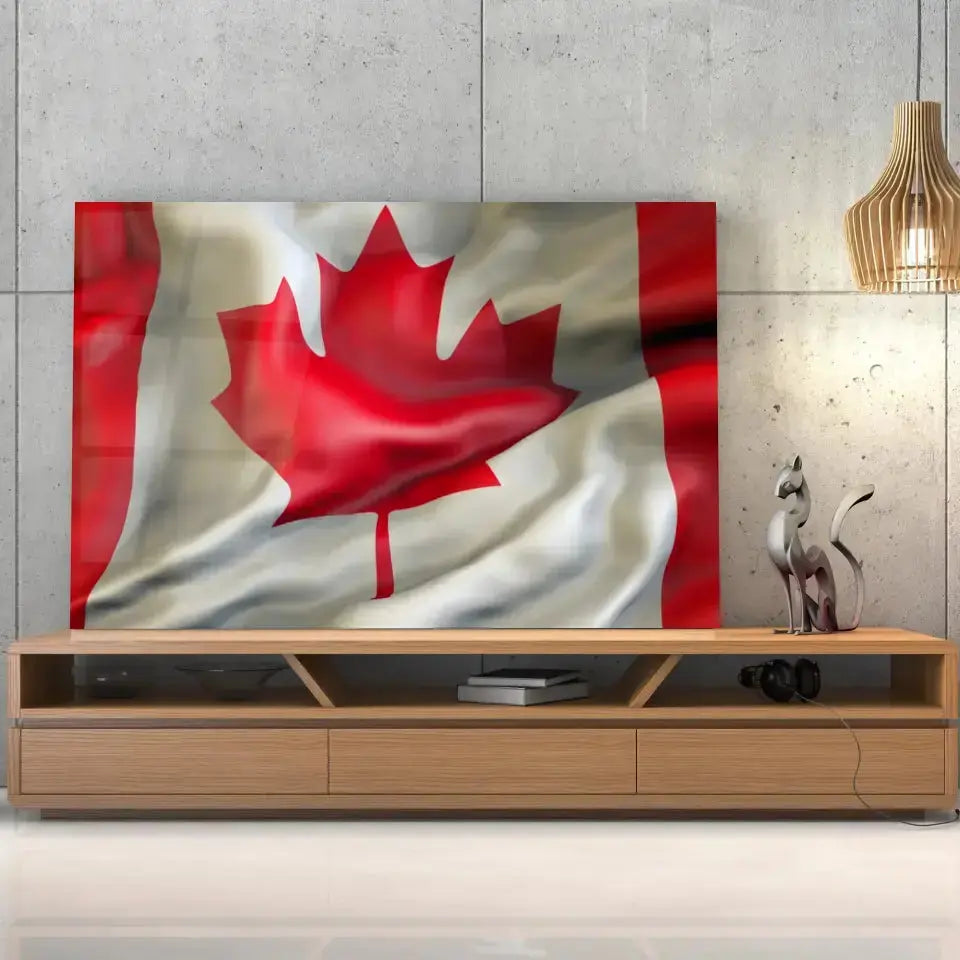 Tableau Drapeau Canada en verre acrylique, posé sur un meuble TV en bois devant un mur en béton