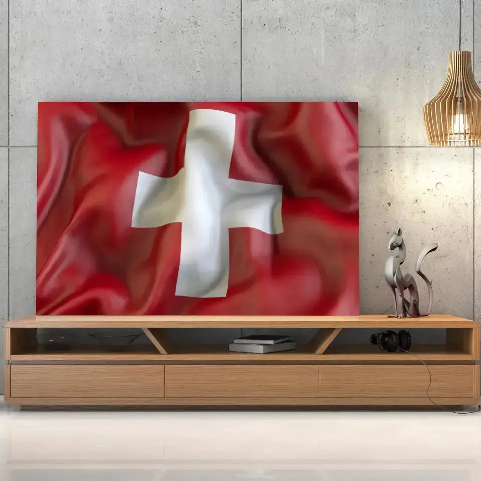 Tableau Drapeau Suisse sur toile, posée sur un meuble TV en bois devant un mur en béton