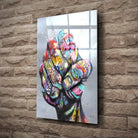 Tableau Street Art Poing de Révolte en verre acrylique, fixé sur un mur de pierre