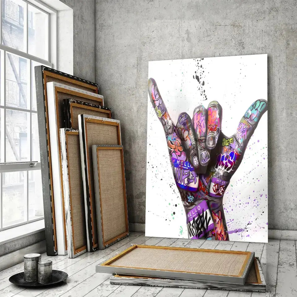 Tableau Street Art Signe Urbain en verre acrylique, posé devant des cadres empilés